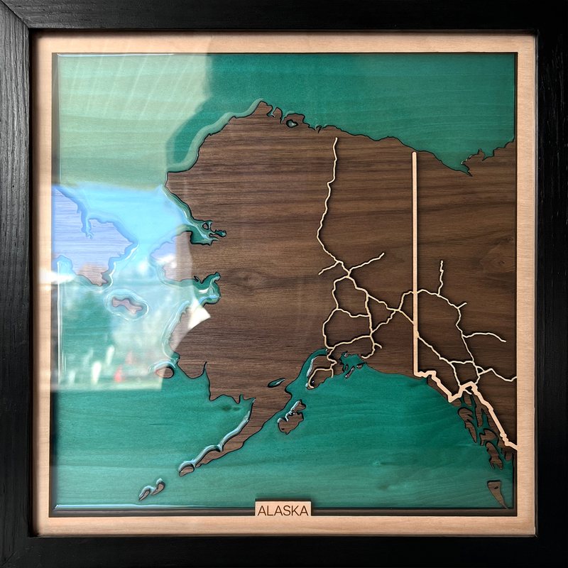 Wooden map of Alaska with turquoise seas
